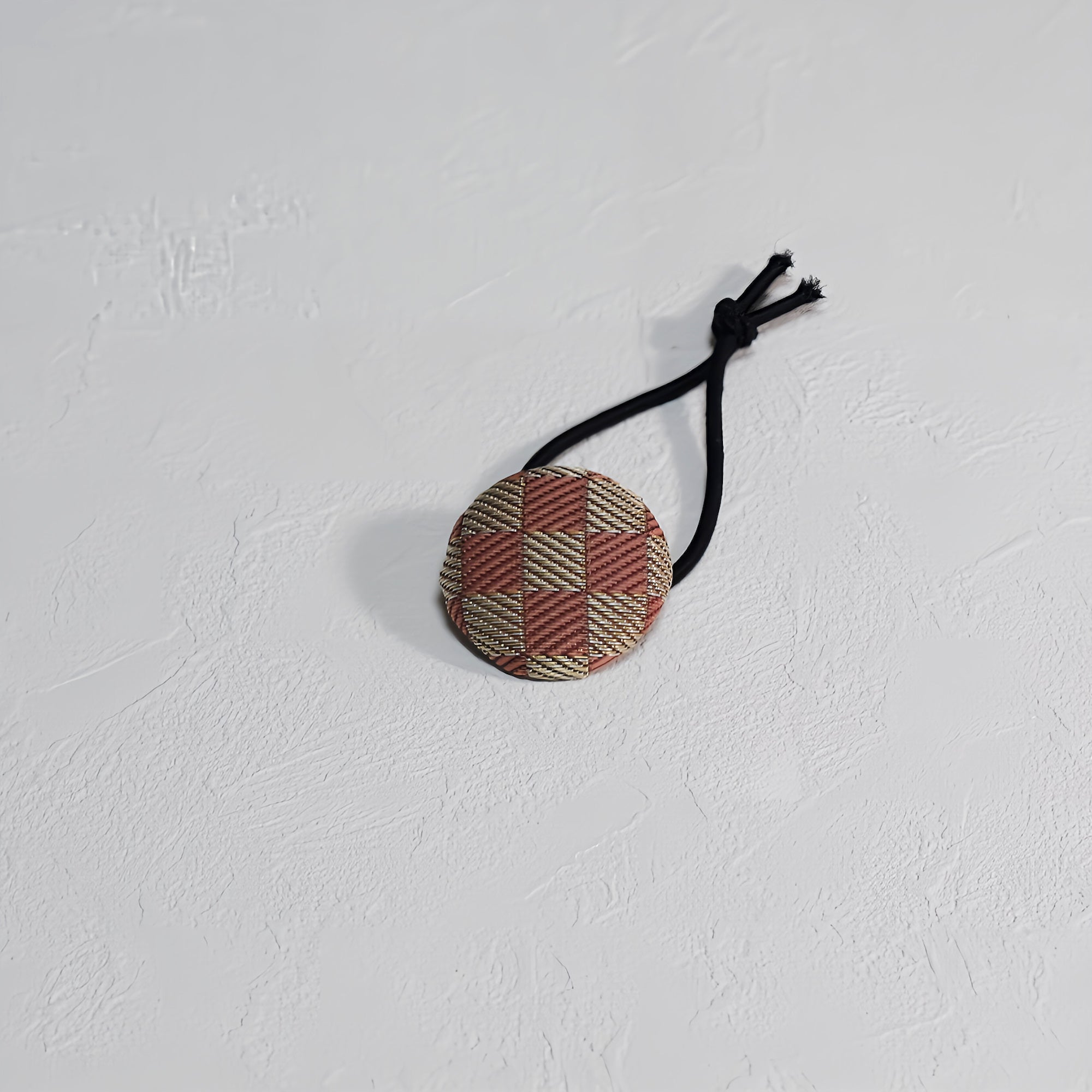 Pink checkered hair tie made from tatami mat edges